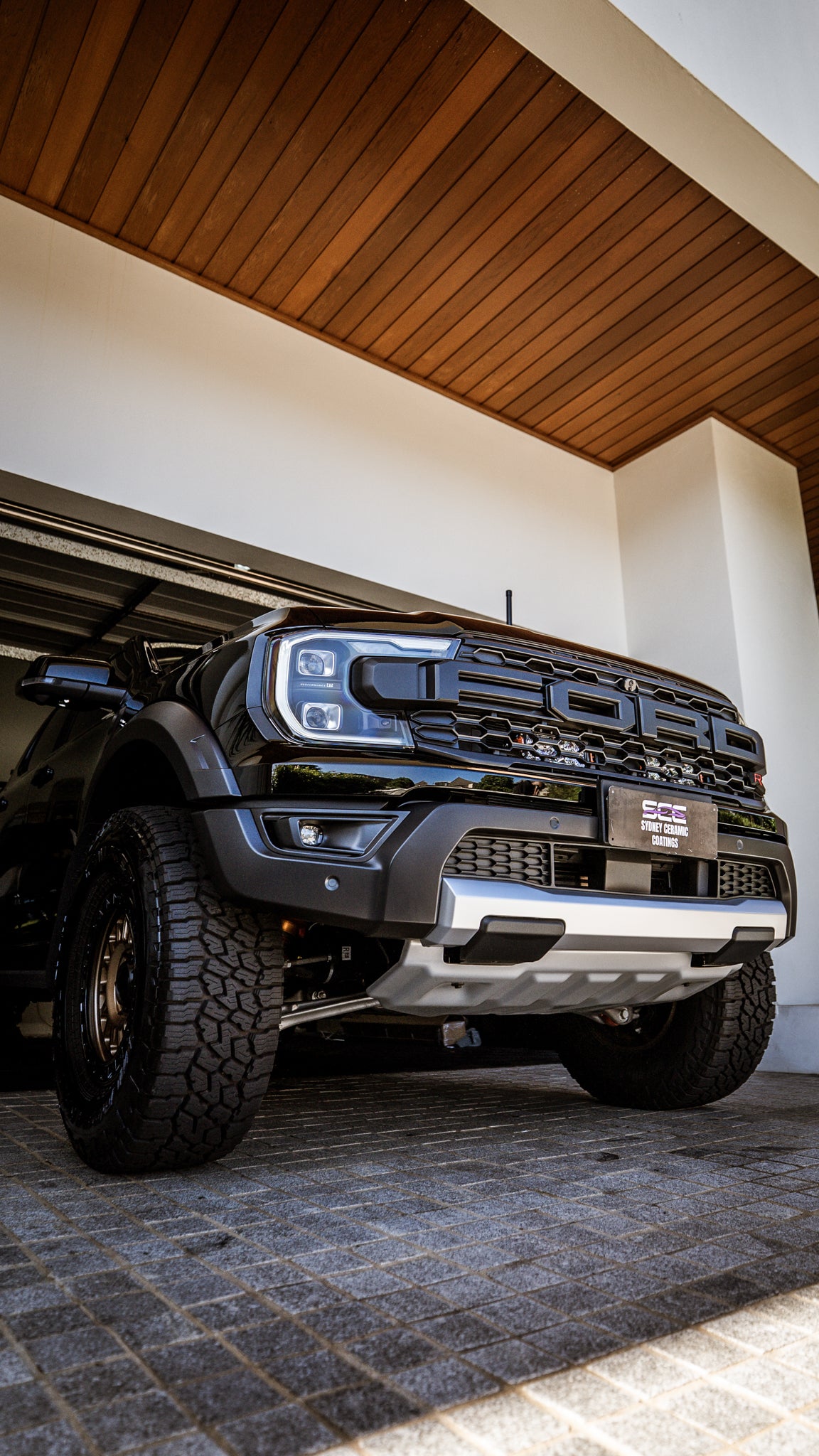 Ford truck parked indoors with wooden ceiling